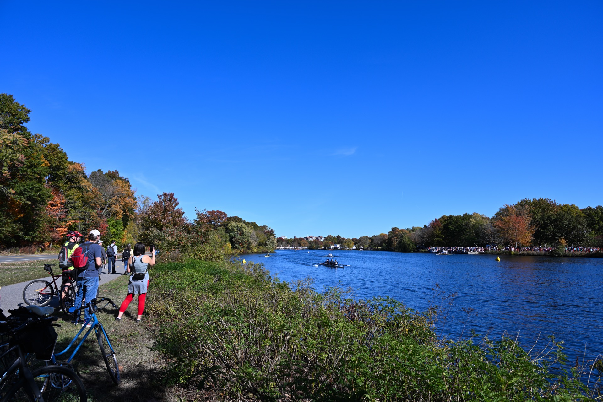 Spectators watch rowers from the Charles River path in Cambridge during the October 2024 Head of the Charles Regatta.