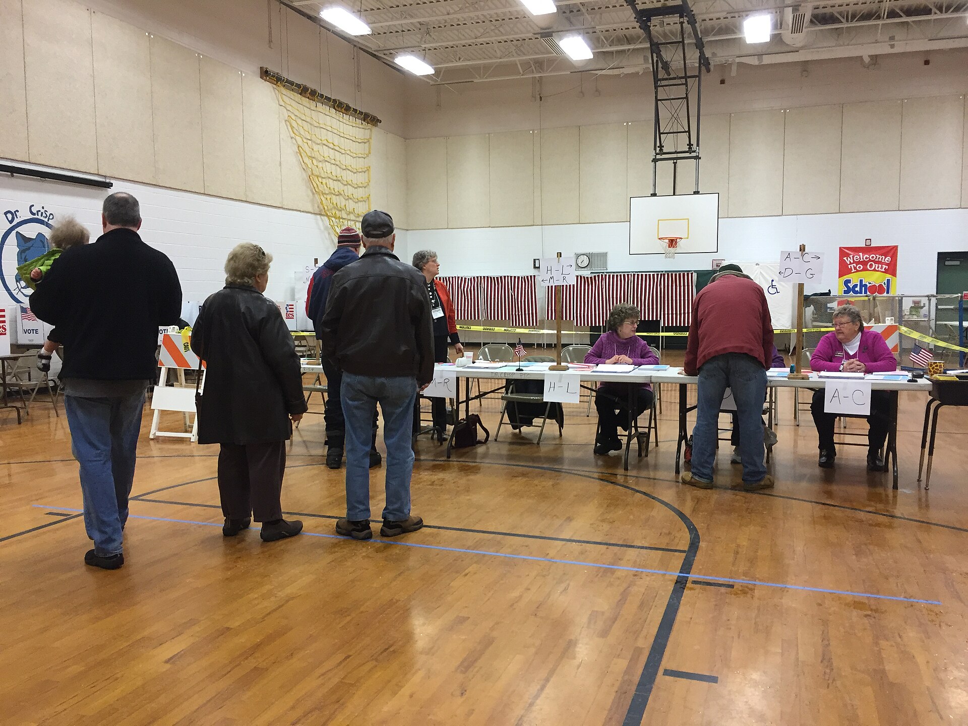Voters wait at check-in tables inside a polling place in Nashua, New Hampshire, in February 2016.