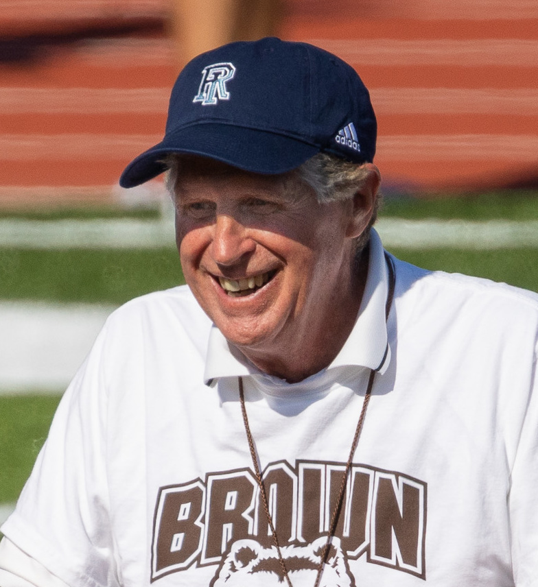 Rhode Island Gov. Dan McKee in a baseball cap and uniform.