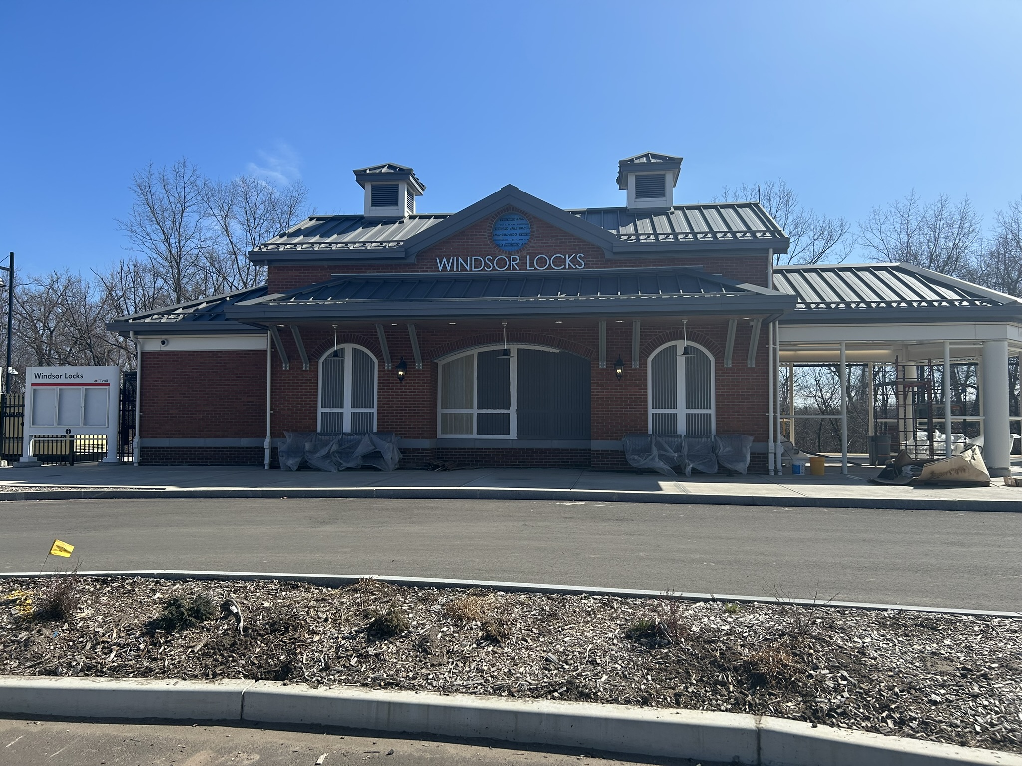 The new brick Windsor Locks station building with CTrail signage during construction.