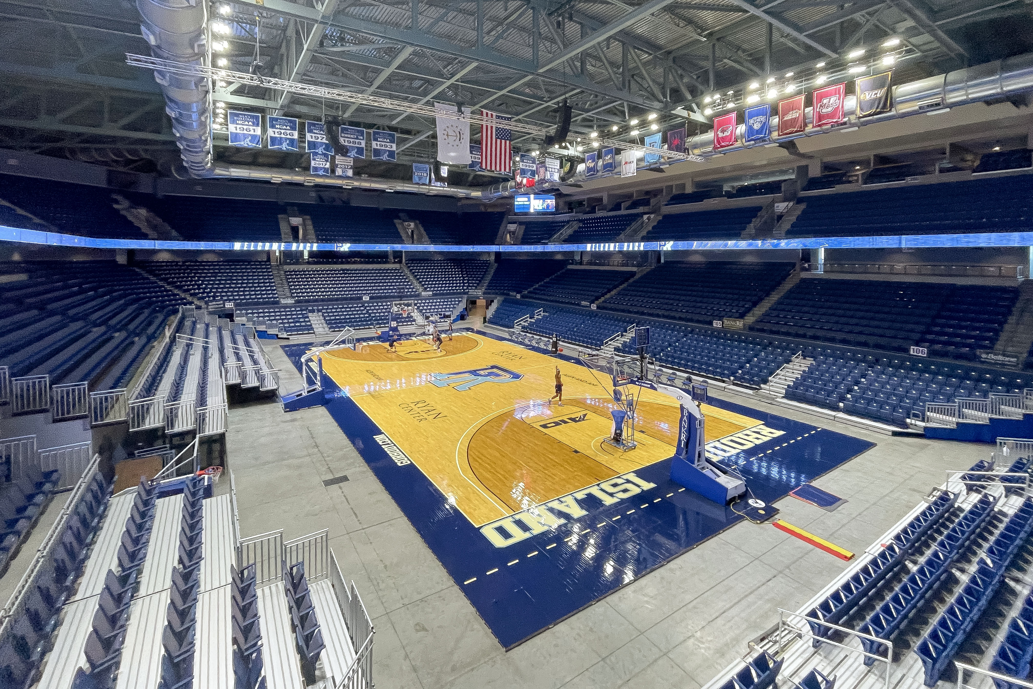 Interior of URI's Ryan Center, showing the basketball court and blue seating.