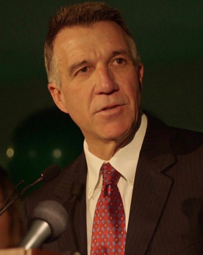 Phil Scott speaks at a lectern with microphones.