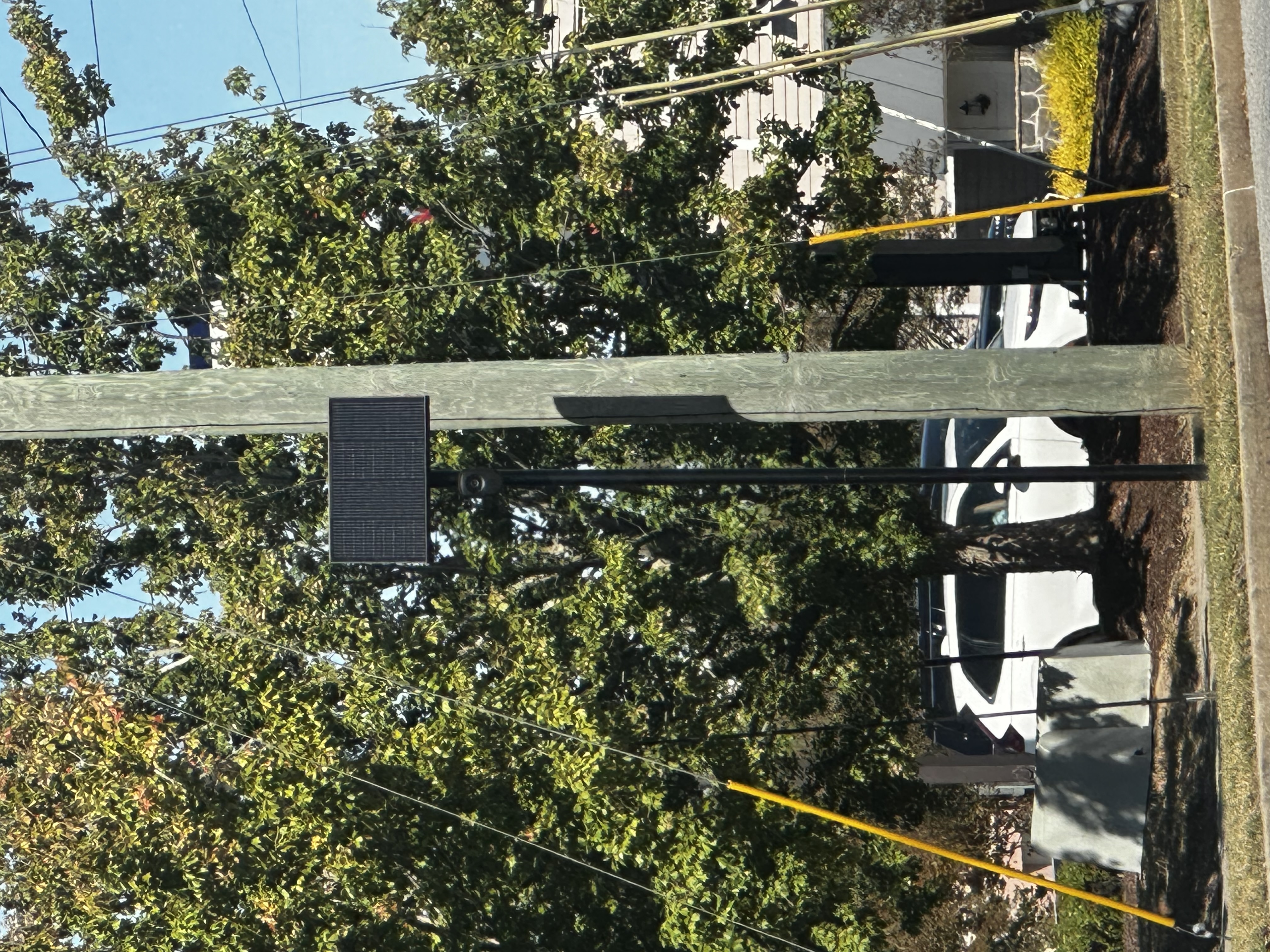 A Flock Safety license-plate camera and solar panel mounted beside a utility pole in Valdosta, Georgia.