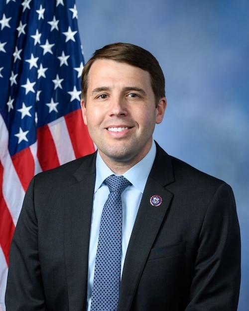 U.S. Rep. Chris Pappas in his official portrait with an American flag.