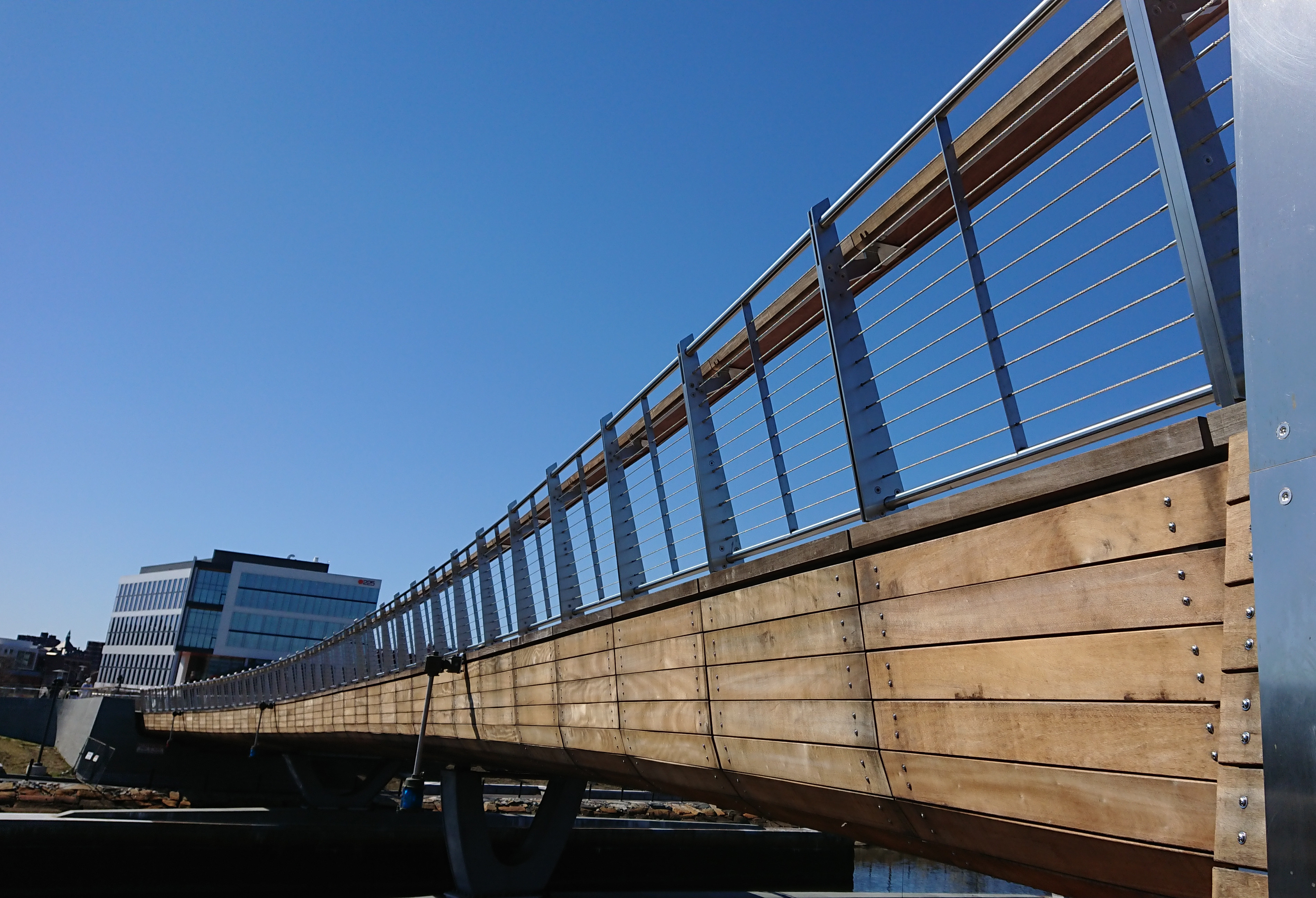 The Michael S. Van Leesten Bridge spans the Providence River, with downtown buildings behind it.
