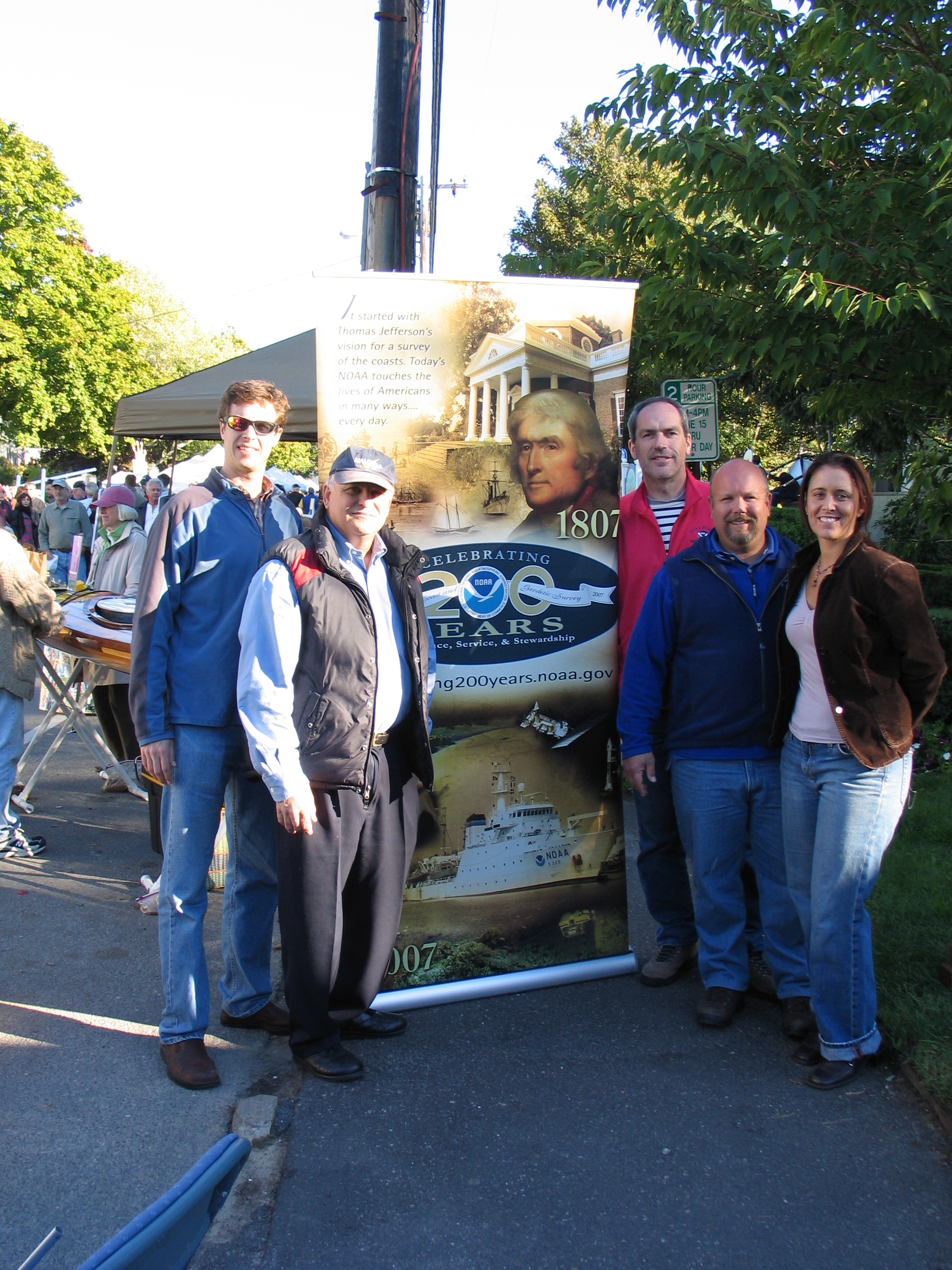 Five people stand beside a NOAA display at the 2007 Wellfleet OysterFest.
